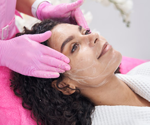 Woman receiving spa facial treatment