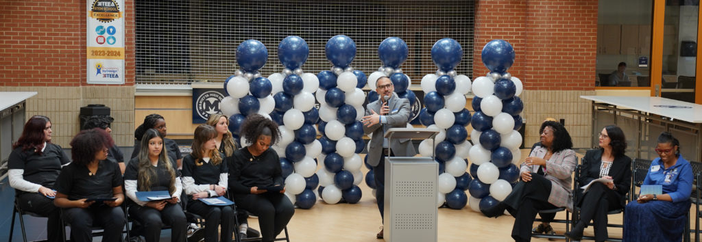 Joe DiDomizio speaks at pinning event from podium