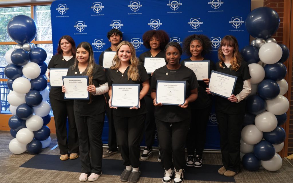 Chatt Tech Marietta High School DE students in CNA program pose with certificates and are wearing pins from the ceremony