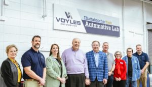 Group of people at Chatt Tech Marietta Campus standing under Voyles Automotive Lab sign