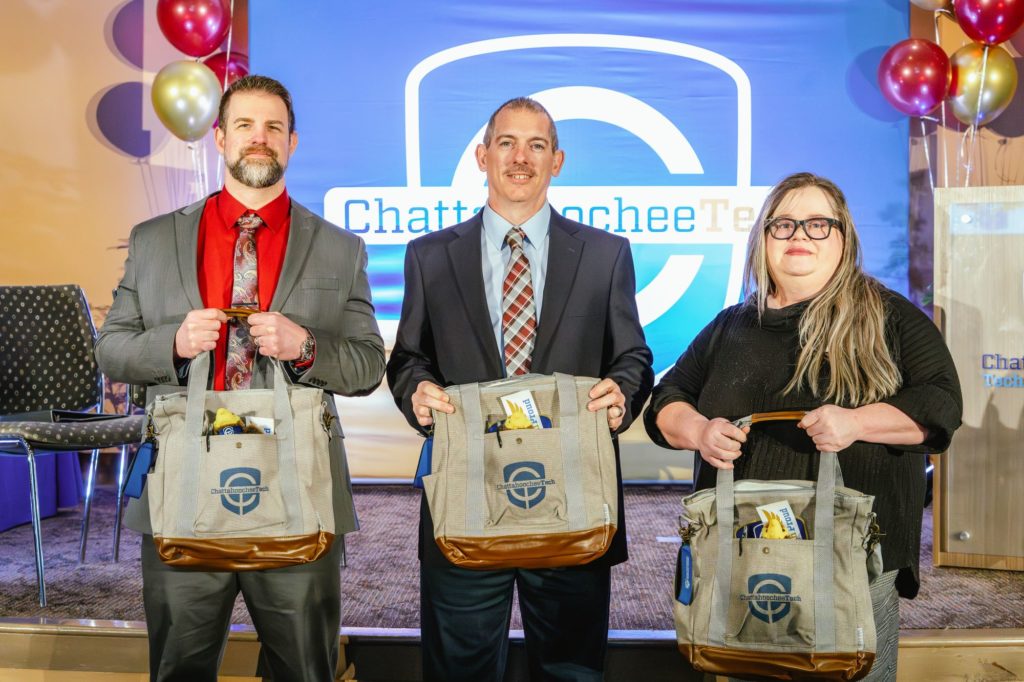 2025 RPA finalists and winner are standing on stage, each holding a gift bag.